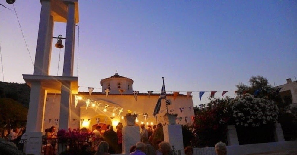 Kythnos, Loutra, The Saints Anargyri Festival - Gastronomy Tours people outside of the church of the Saints at Kythnos, Loutra, Greece that commemorate festival of her birth by night